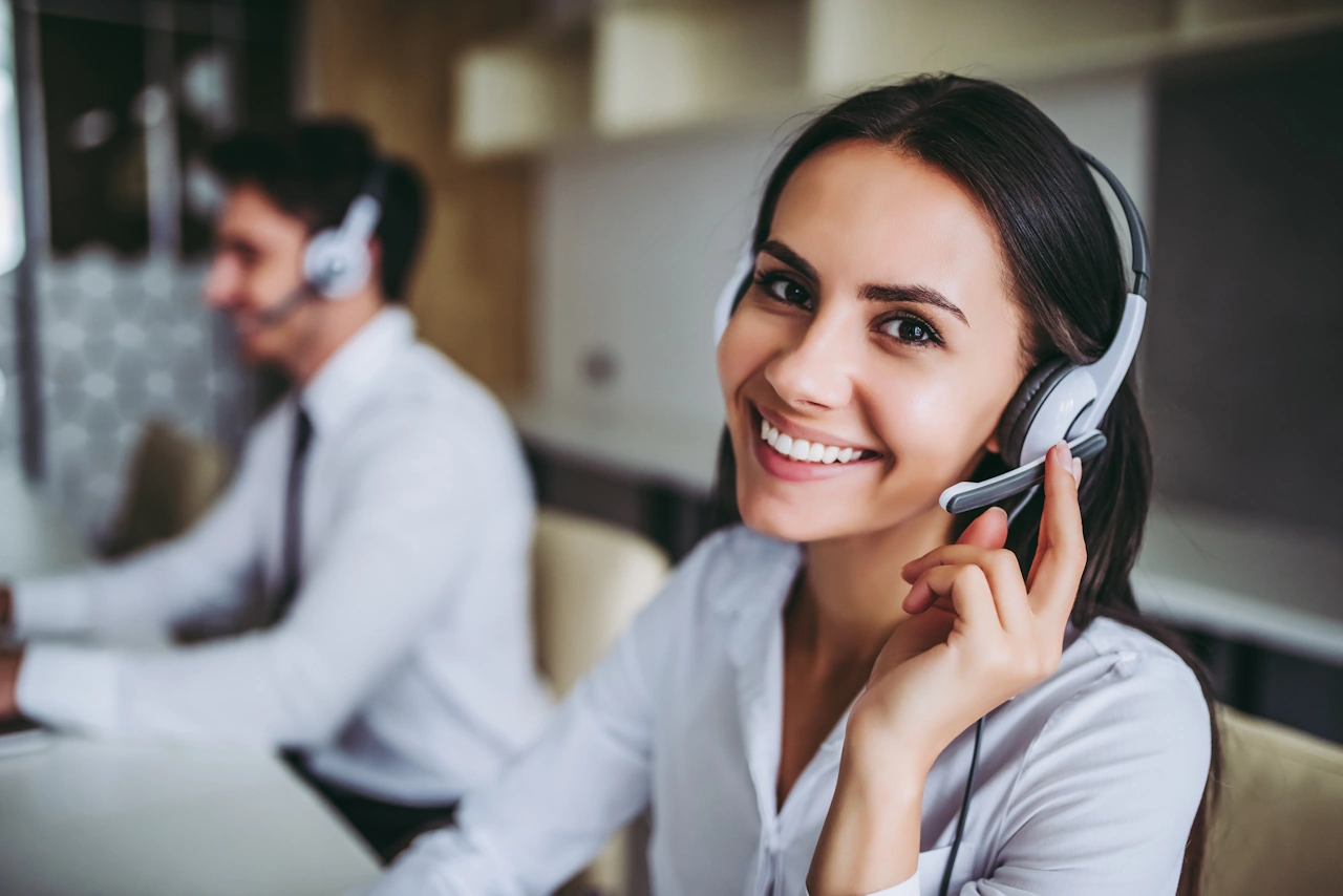 Monitoring Specialist Smiling and Speaking with Headset